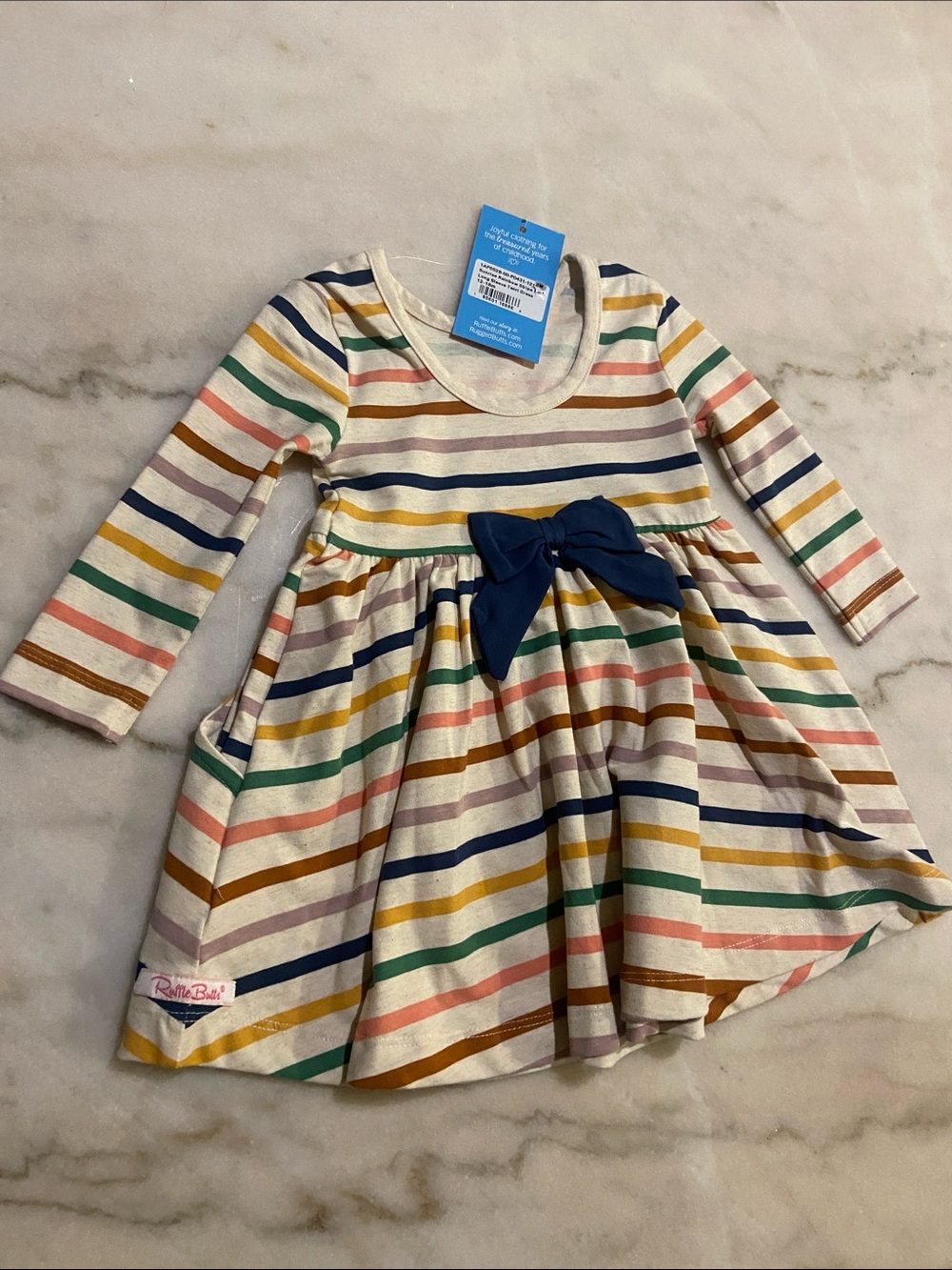 Ruffle Butts Cream Dress with Multicolor Stripes & Navy Bow